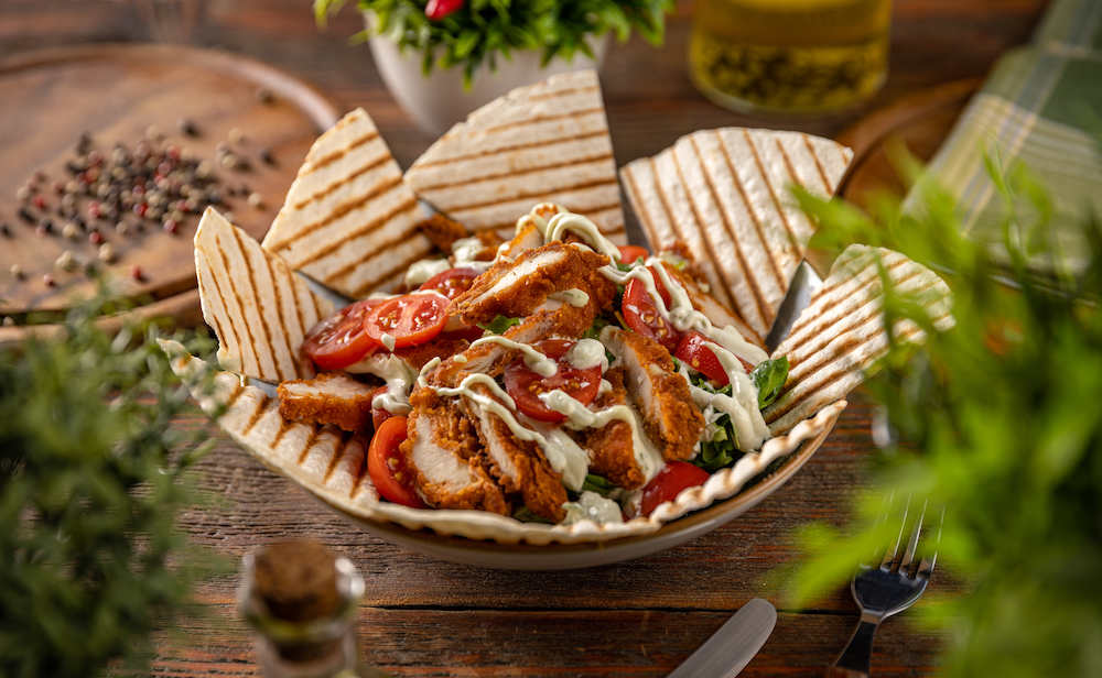 Healthy lunch menu. Breaded chicken breast with fresh vegetable salad of lettuce served with tortilla low salt diet to improve your prostate health